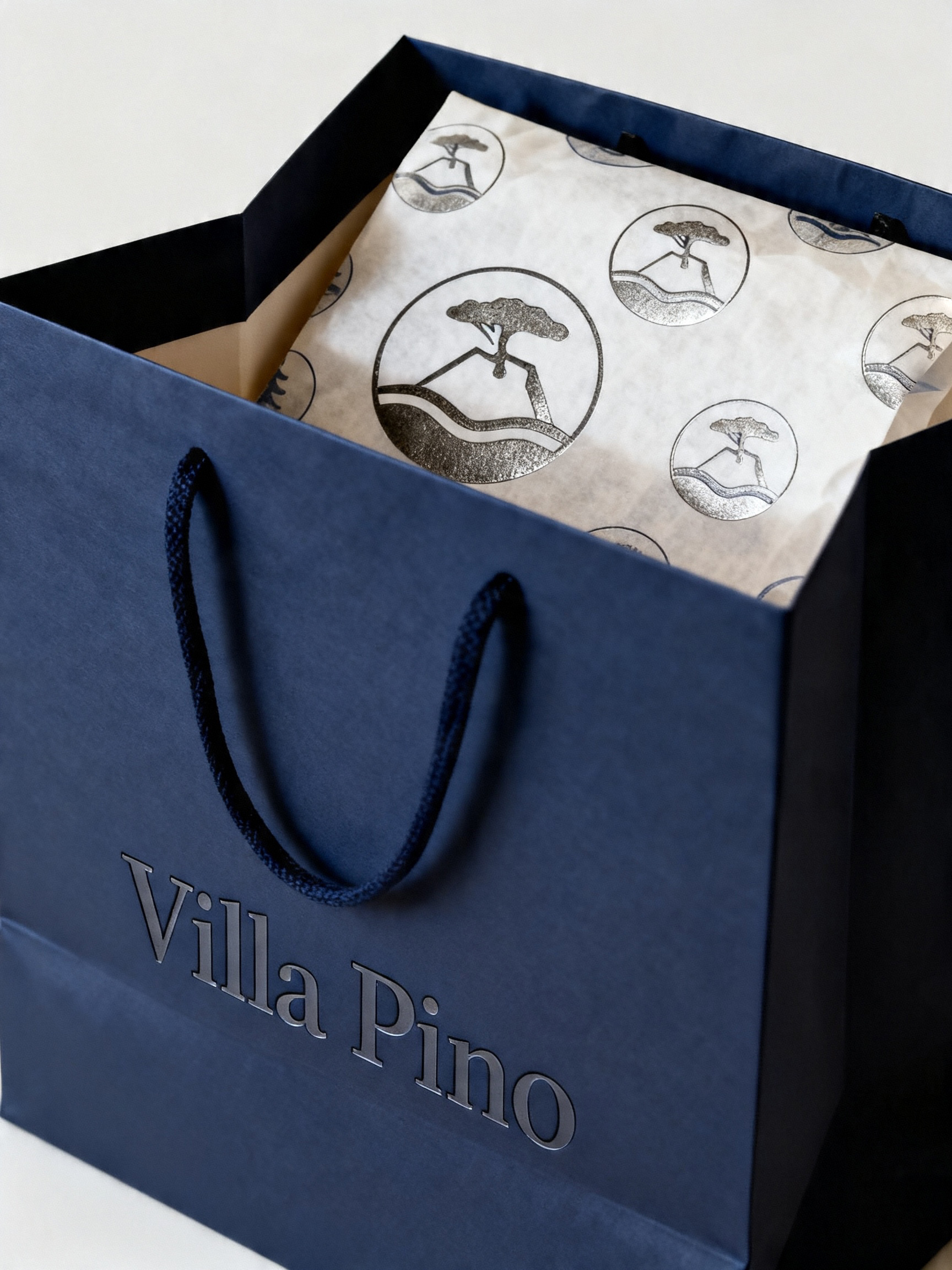 Villa Pino navy shopping bag with branded tissue paper inside